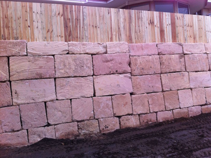 A grade sandstone and paling fence